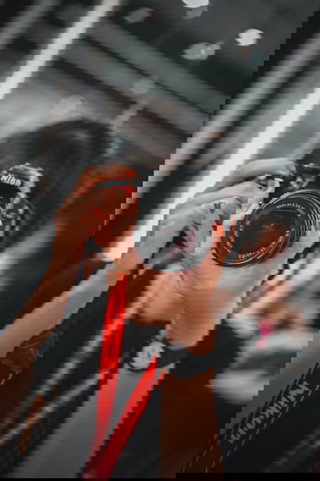 Woman using a Nikon DSLR