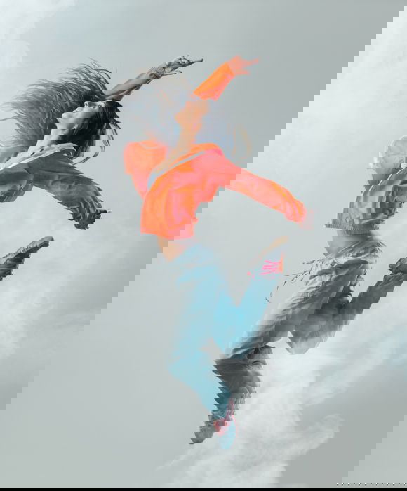 A woman leaping in the air shot with a faster shutter speed