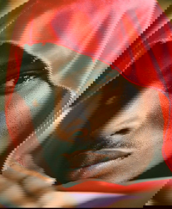Close portrait of a man in a red hood