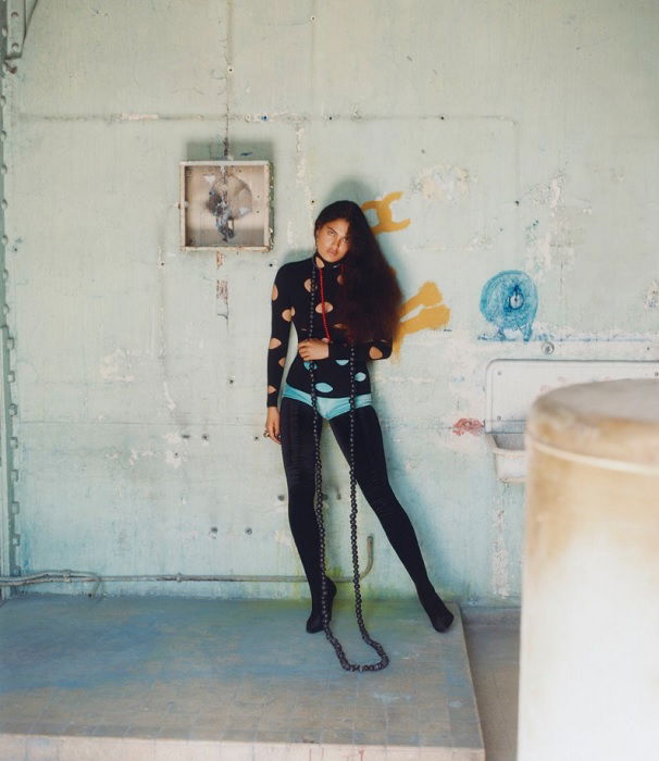 Woman posing in the back of a factory
