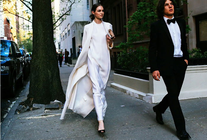 Woman in white walking down street