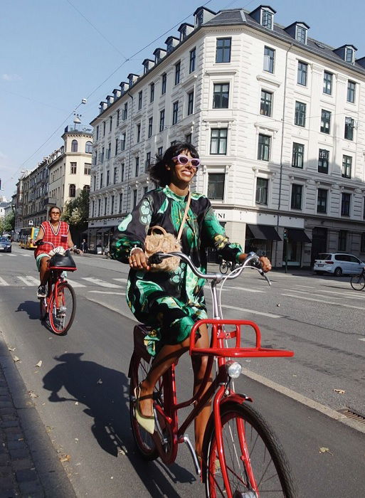 Two elegant ladies on bicycles